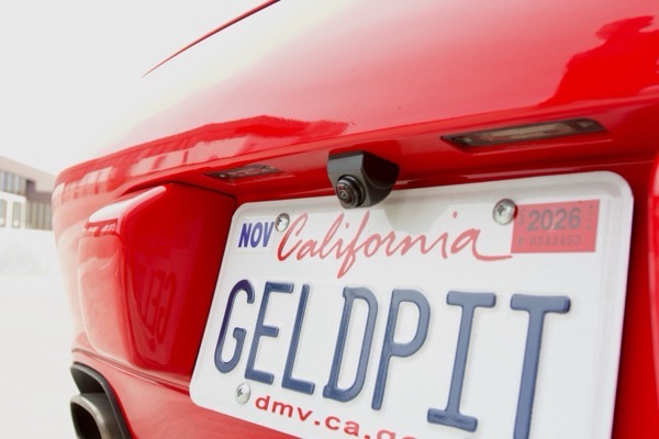 Aftermarket backup camera mounted above license plate