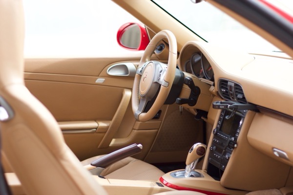 Driver side cockpit view showing steering wheel, dashboard, and center console